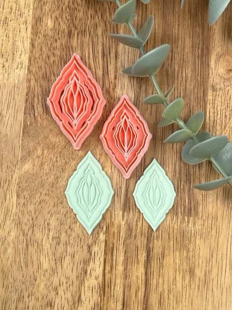 Vagina clay cutter set with eco-friendly PLA material on wooden surface.