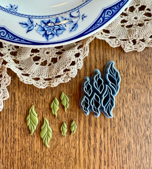 LEAVES CLUSTER PACK clay cutters on wooden table with crochet and ceramic plate.