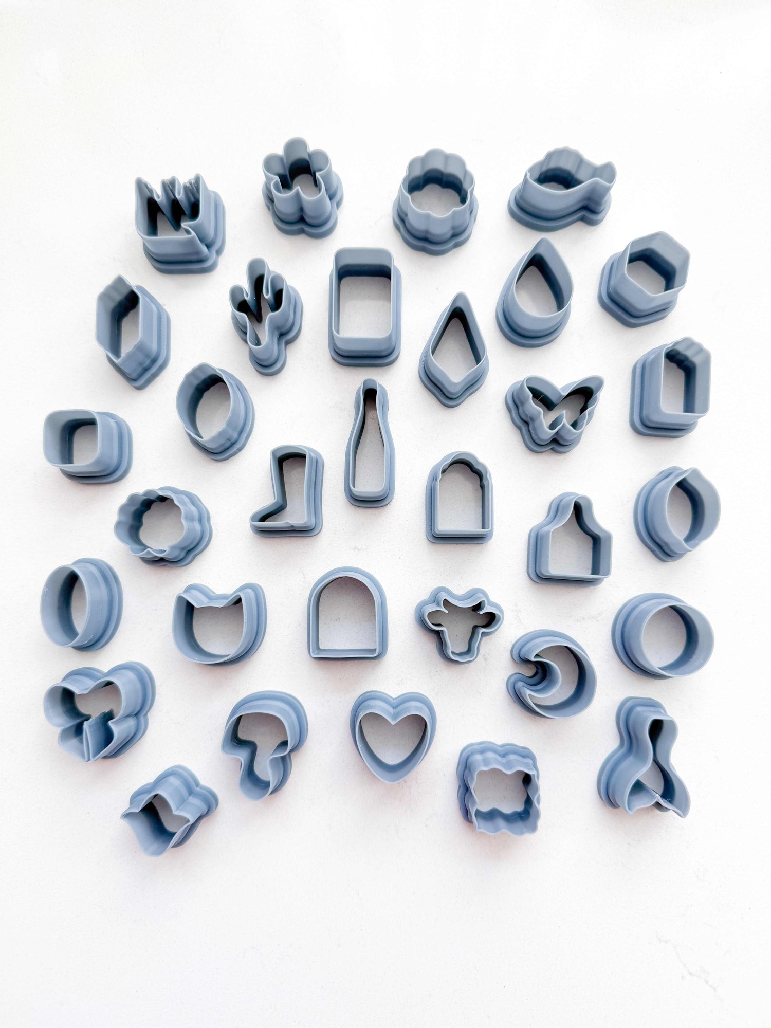 Polymer clay cutters from THE CHARM BAR in various sizes for precise charm shapes